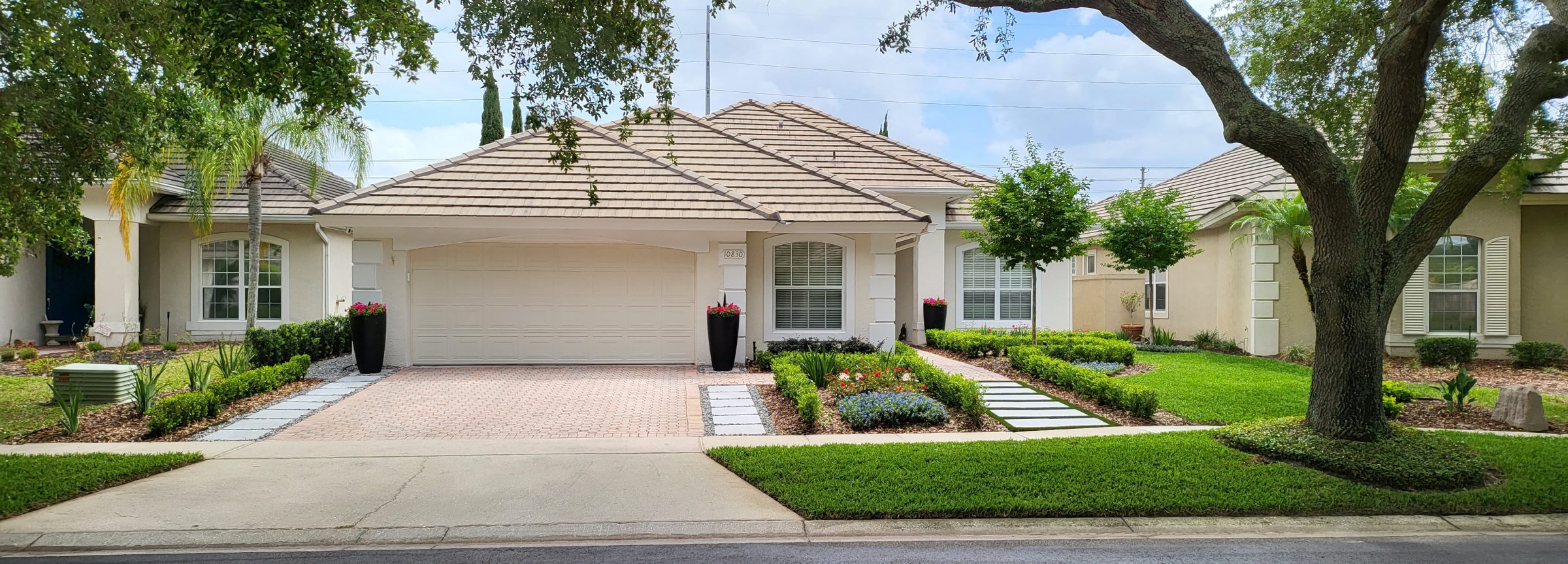 Single-story house with well-maintained lawn and garden.